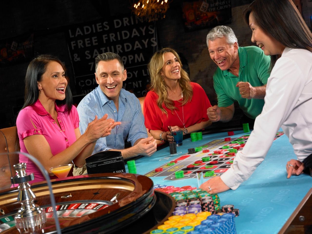 Guests and a dealer around a casino table